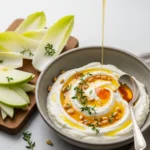 Creamy whipped ricotta dip with hot honey and olive oil garnish