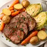 Corned beef and cabbage plated with potatoes carrots and mustard for dinner