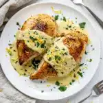 Creamy lemon garlic chicken with golden seared breasts in glossy sauce
