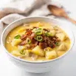 Creamy crockpot potato soup with melted cheese bacon and fresh chives