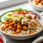 Healthy chicken and sweet potato rice bowl recipe in a ceramic dish.