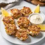 Mini crab cake bites with crispy golden brown texture and creamy remoulade sauce.