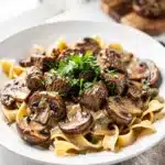 Creamy slow cooker beef stroganoff with tender beef and mushrooms over noodles