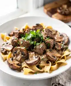 Creamy slow cooker beef stroganoff with tender beef and mushrooms over noodles