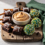 Super Bowl dessert platter with football themed treats and peanut butter dip.