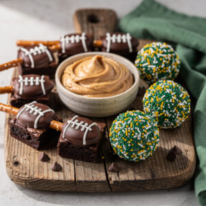 Super Bowl dessert platter with football themed treats and peanut butter dip.
