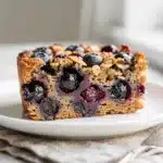 Creamy baked oatmeal with fresh blueberries in a cozy homemade breakfast.