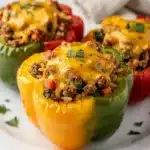 Cheesy ground beef stuffed peppers with melted golden brown cheese topping