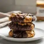 Chocolate peanut butter cookies with crispy edges and chewy glossy centers.