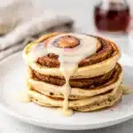 Fluffy golden pancake with cinnamon swirl and cream cheese glaze.