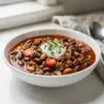 Hearty classic beef and bean chili topped with cheese and fresh cilantro.