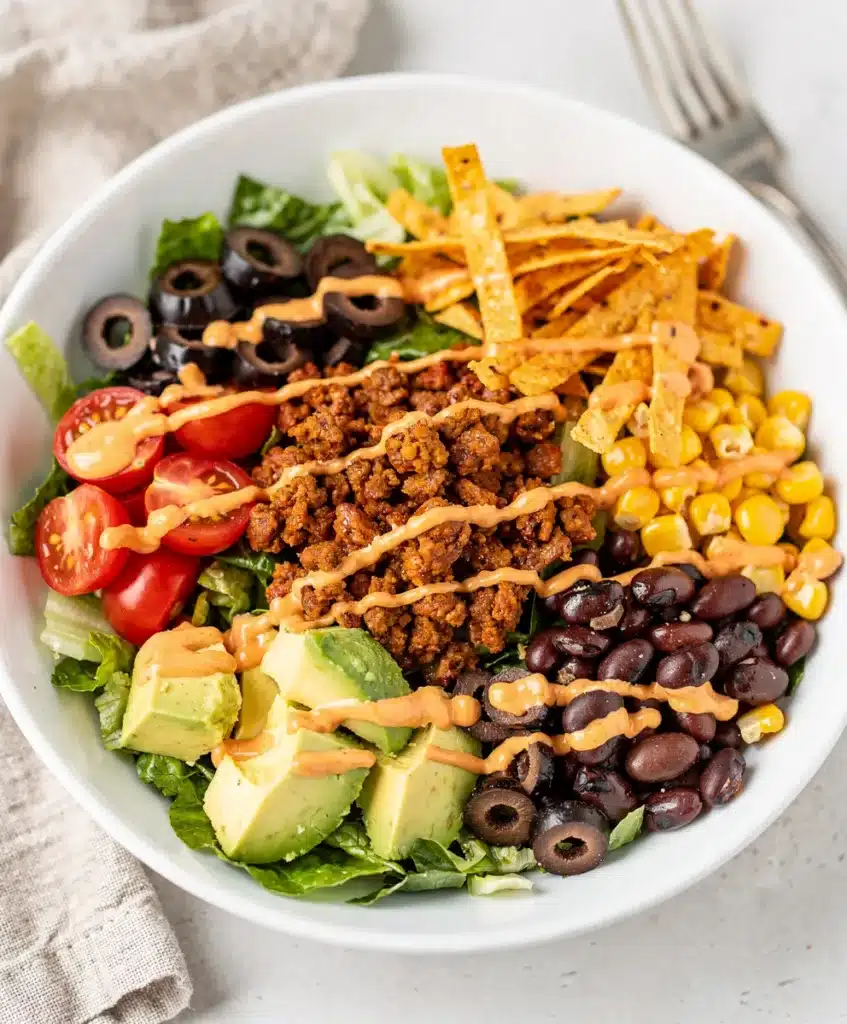 Colorful ground beef taco salad with fresh lettuce and creamy avocado.