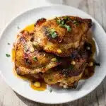 Irish whiskey glazed chicken thighs in a rustic cast iron skillet