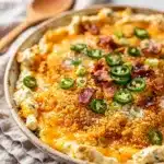 Creamy jalapeno popper dip with golden panko topping in rustic dish.
