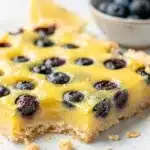 Lemon blueberry bars with creamy curd and a golden shortbread crust.