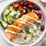 Mediterranean salmon bowls with creamy yogurt sauce and crispy seared salmon.