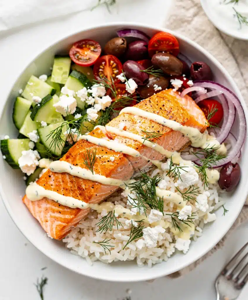 Mediterranean salmon bowls with creamy yogurt sauce and crispy seared salmon.