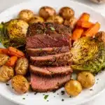Oven roasted corned beef and cabbage recipe on a rustic wooden board