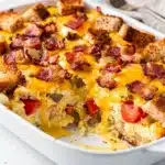 Overnight bacon egg breakfast casserole with crispy bacon and melted cheese
