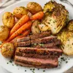 Rustic sheet pan corned beef and cabbage with roasted vegetables and thyme.