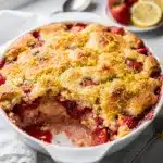 Strawberry lemon dump cake with white chocolate chips in baking dish.