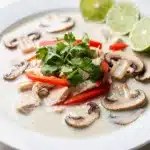 Creamy Thai coconut chicken soup with tender chicken and fresh cilantro garnish