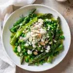 Bright asparagus pea salad with almonds and feta in lemony vinaigrette.