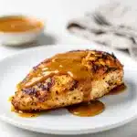 Baked honey mustard chicken recipe with glossy sauce in close up