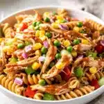Creamy barbecue chicken pasta salad with corn peas and bell peppers