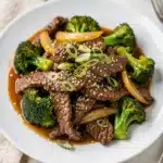Beef and broccoli stir fry with glossy sauce and crisp green florets.
