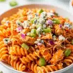 Buffalo chicken pasta salad with creamy dressing and crisp celery in a bowl