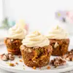 Moist carrot cake cupcakes topped with creamy cream cheese frosting.