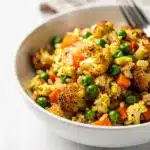Healthy cauliflower fried rice recipe with crispy egg and colorful vegetables.
