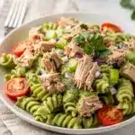 Creamy avocado tuna pasta salad recipe with rotini tomatoes and celery