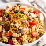 Creamy chicken bacon ranch pasta salad with fresh tomatoes and cheddar cheese.