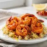 Harissa shrimp with fluffy couscous in a bright, homemade, close-up food photo.