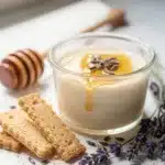 Creamy honey lavender panna cotta dessert in a clear glass with drizzle