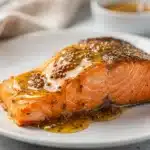 Honey mustard salmon recipe with creamy glaze in natural light closeup