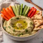 Creamy lemon herb hummus garnished with fresh dill and olive oil