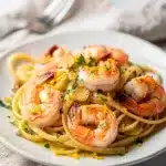 Creamy olive oil shrimp pasta with linguine lemon and fresh parsley garnish