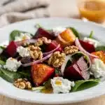 Roasted beet and goat cheese salad with walnuts on fresh spring greens.