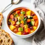 Hearty slow cooker vegetable soup with colorful beans and corn in tomato broth.
