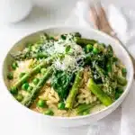 Creamy spring vegetable orzo with asparagus peas dill and Parmesan cheese