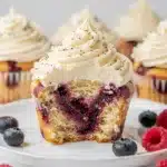 Vanilla bean cupcakes with a vibrant berry swirl and creamy frosting.
