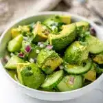 Healthy avocado cucumber salad recipe in a bright, fresh, and vibrant food photo.
