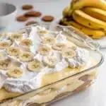Bakery style banana pudding in a clear glass trifle bowl with creamy layers