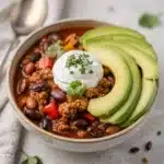 Hearty turkey chili soup with creamy beans in a rustic bowl.