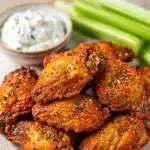 Crispy air fryer wings with blue cheese dressing and celery sticks.
