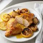 Crispy Greek lemon chicken recipe with roasted lemons and fresh oregano.