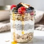 Creamy overnight oats with berries and banana in a glass jar